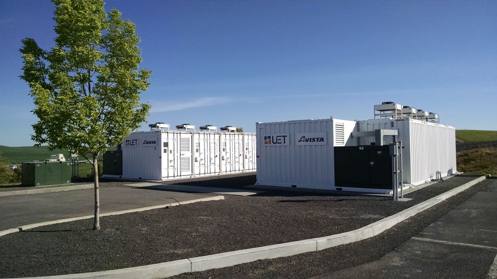 Rows of containerised battery storage units at a grid-scale storage site
